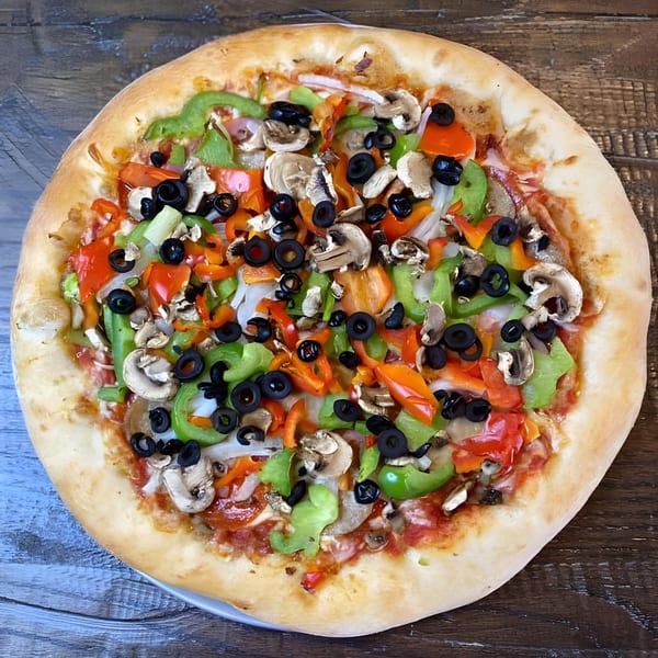 A No Name Pizza with green peppers, red peppers, mushrooms, onions, and black olives.